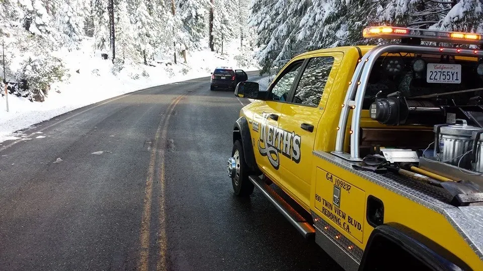 Keith's Towing truck responding on a snowy mountain road